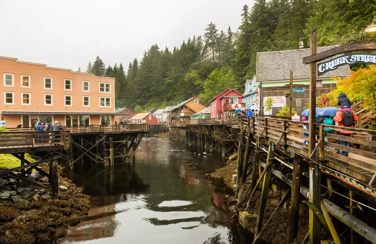 The historic Creek Street boardwalk on its pilings in Ketchikan, Alaska, seen along the length of the creek